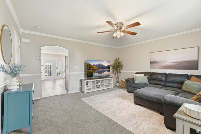 99 Penhurst Place Logan, UT 84341 - Photo 4 of 34 Living area featuring neutral wall paint, white crown molding, and wainscoting
