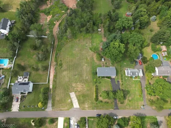 an aerial view of a residential houses with outdoor space