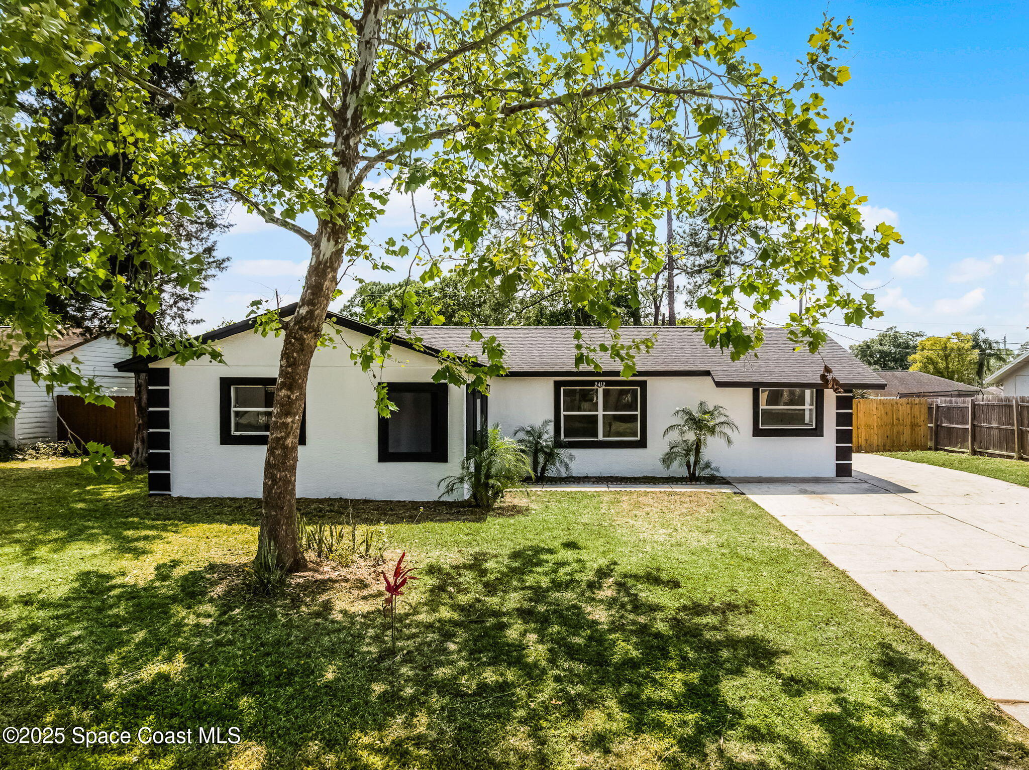 a house view with a sitting space and garden