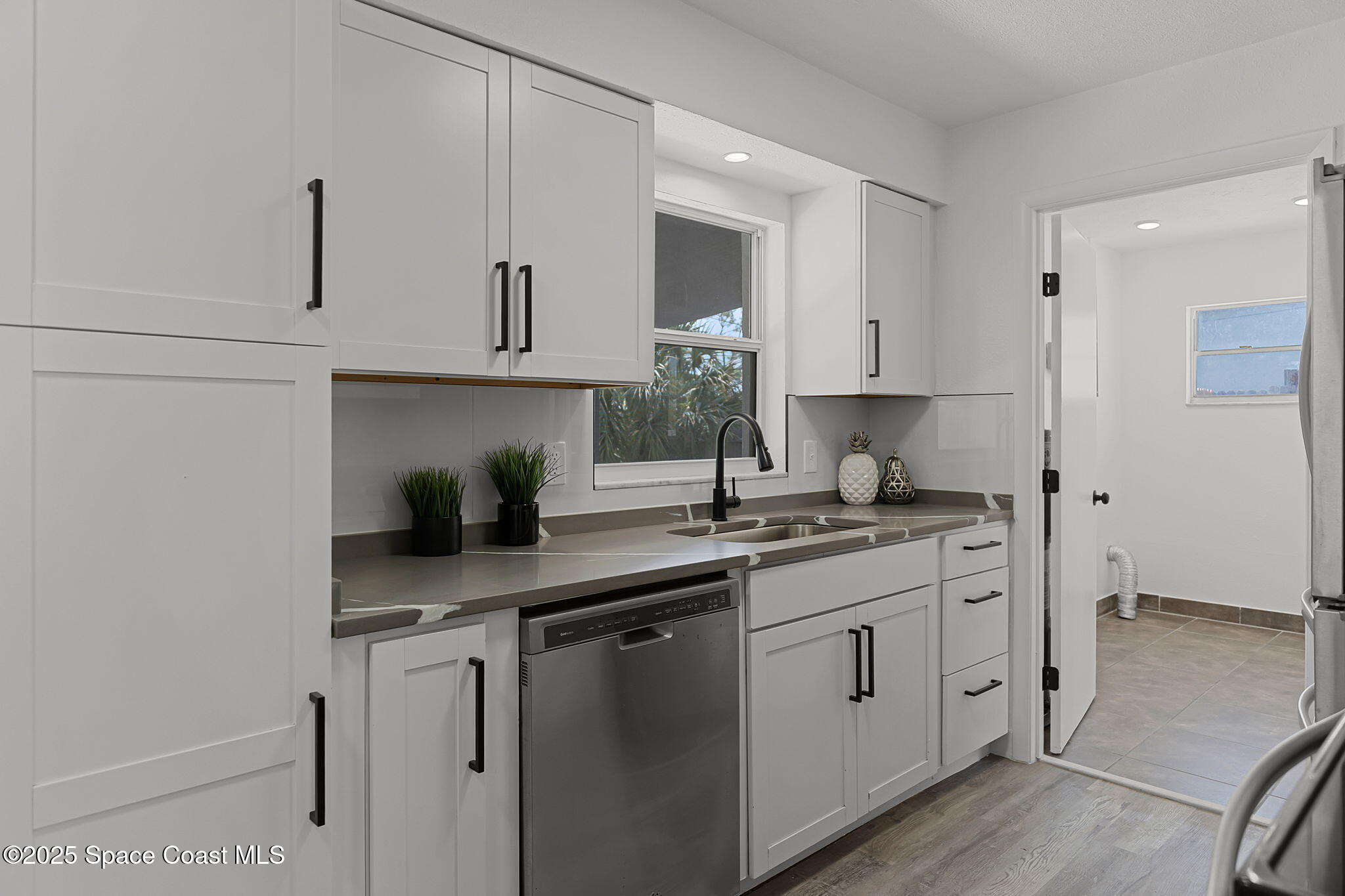2412 Yule Tree Drive Edgewater, FL 32141 - Photo 12 of 35 a kitchen with white cabinets and sink