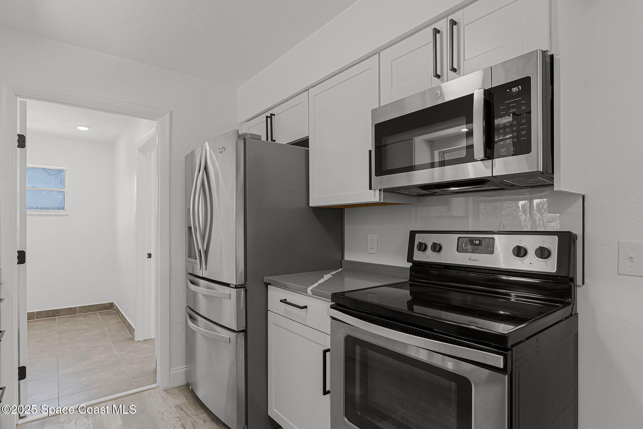 2412 Yule Tree Drive Edgewater, FL 32141 - Photo 13 of 35 a kitchen with stainless steel appliances a stove a microwave and a refrigerator