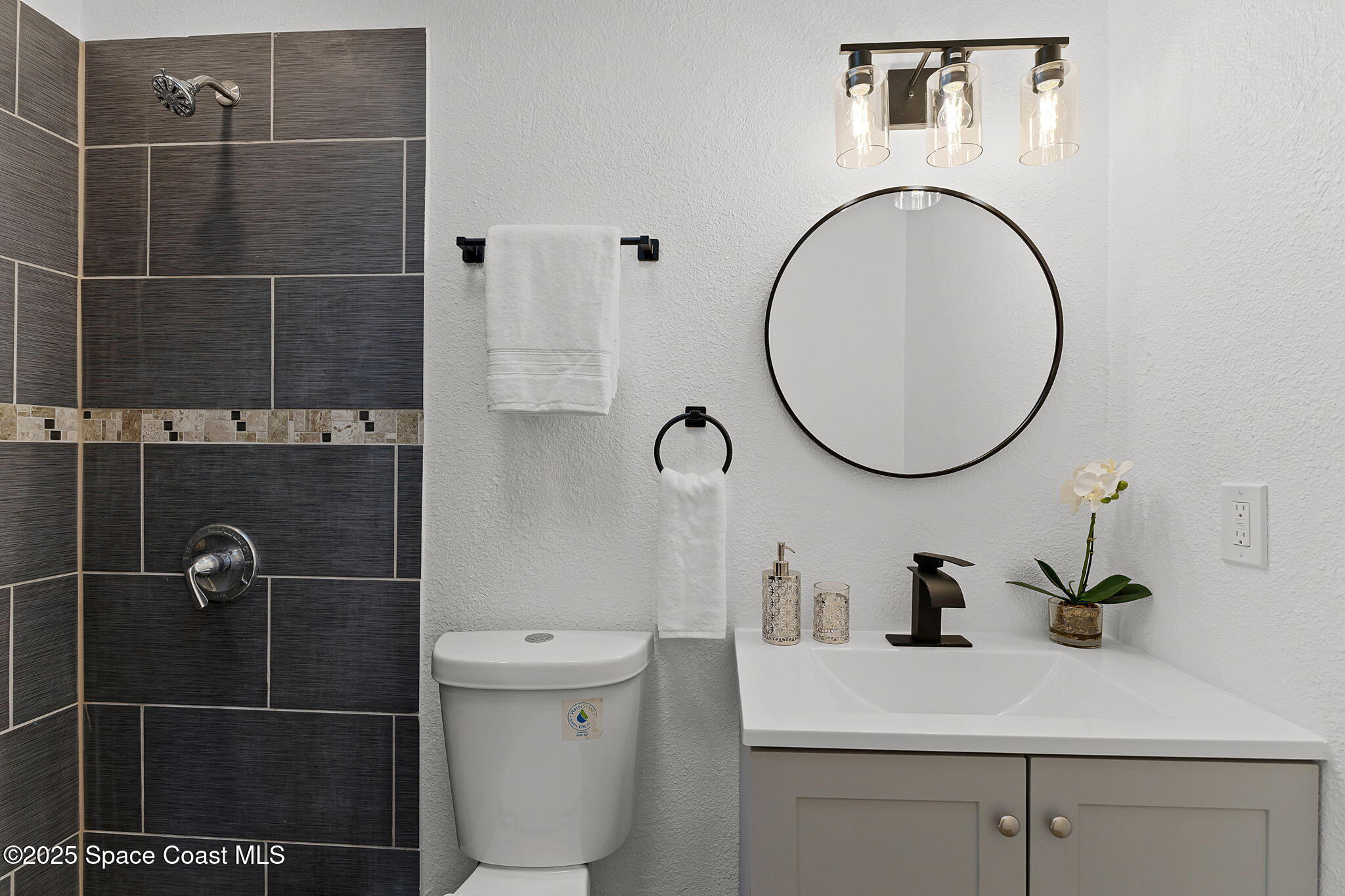 2412 Yule Tree Drive Edgewater, FL 32141 - Photo 17 of 35 a bathroom with a sink toilet a mirror and vanity