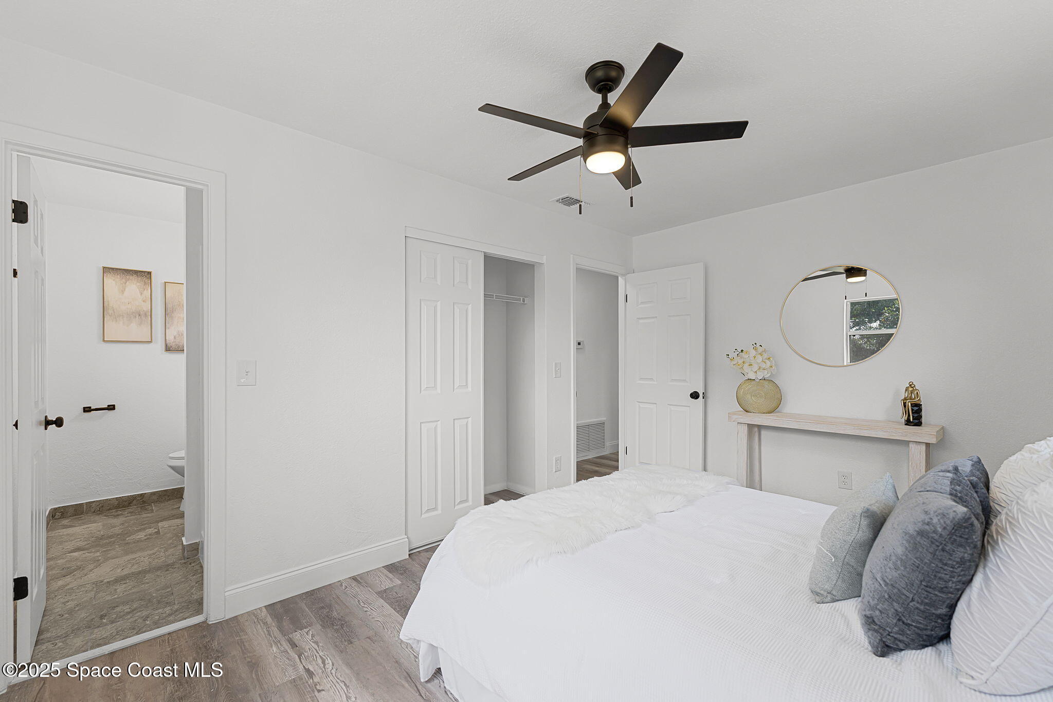 2412 Yule Tree Drive Edgewater, FL 32141 - Photo 19 of 35 a bedroom with a bed and cabinets