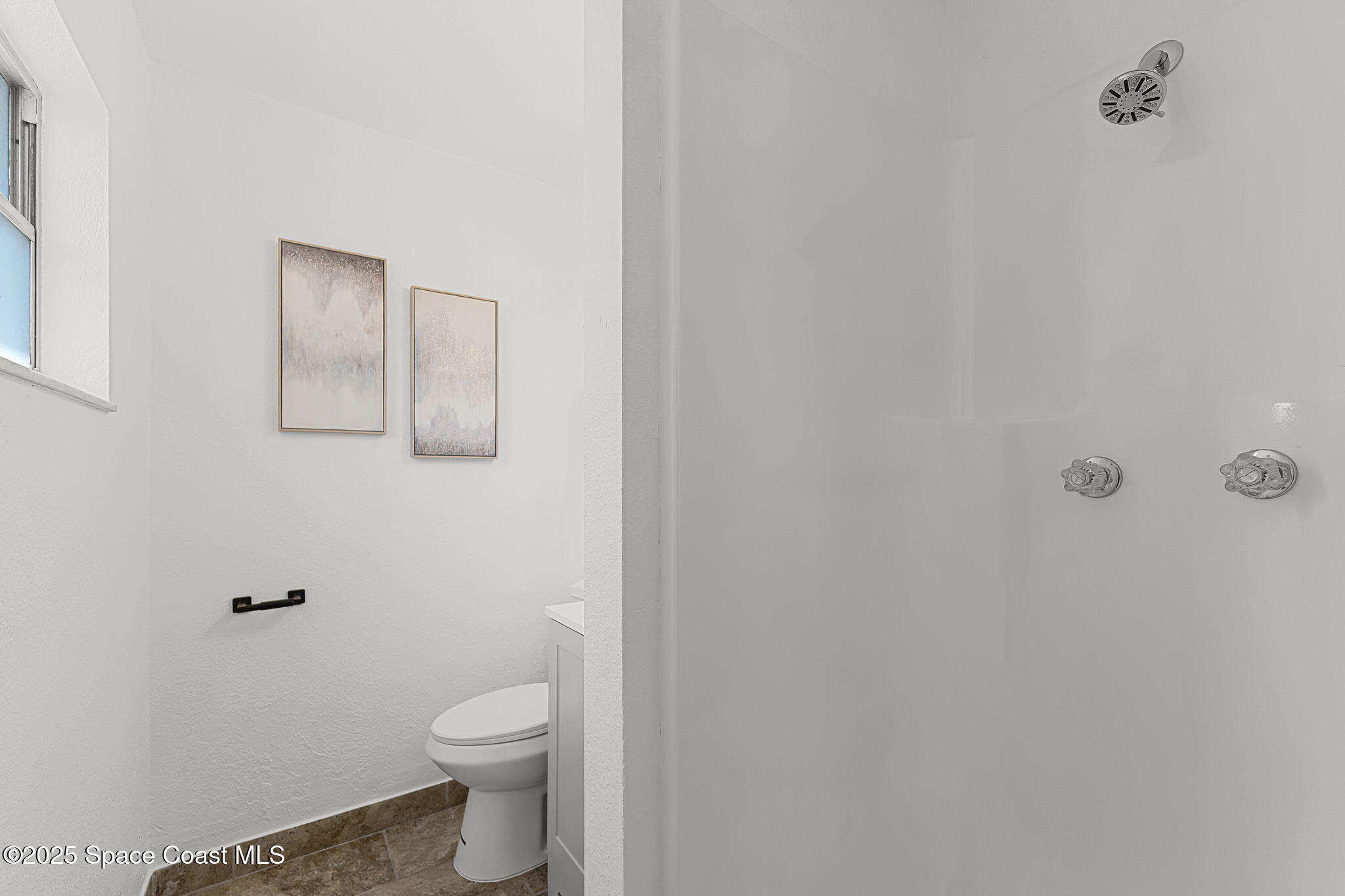 2412 Yule Tree Drive Edgewater, FL 32141 - Photo 20 of 35 a bathroom with a toilet and a shower