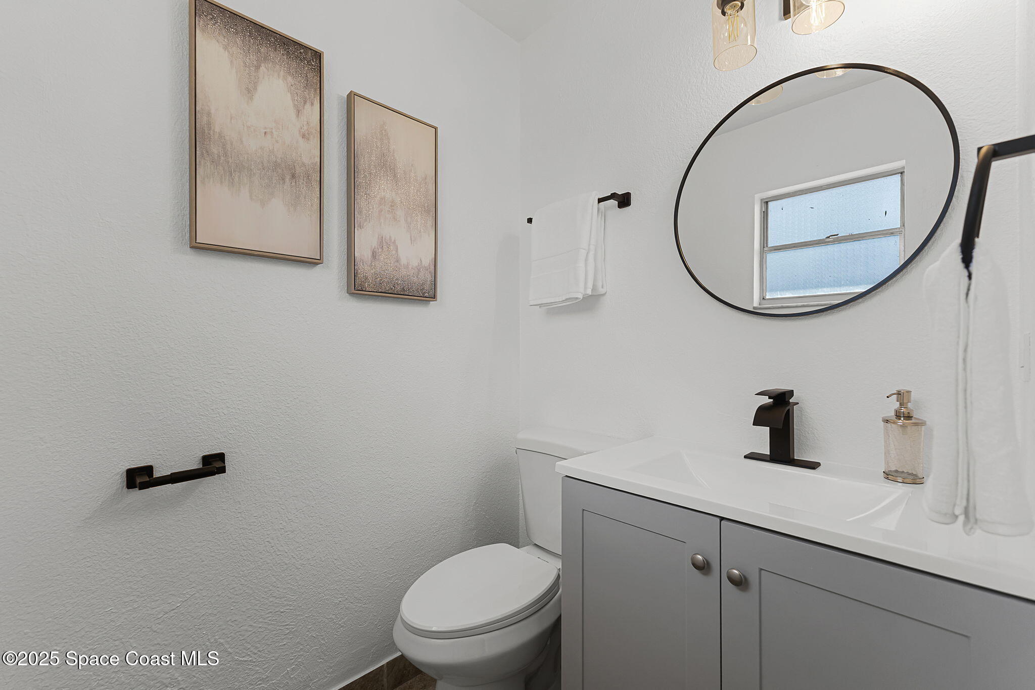 2412 Yule Tree Drive Edgewater, FL 32141 - Photo 21 of 35 a bathroom with a toilet a sink and mirror