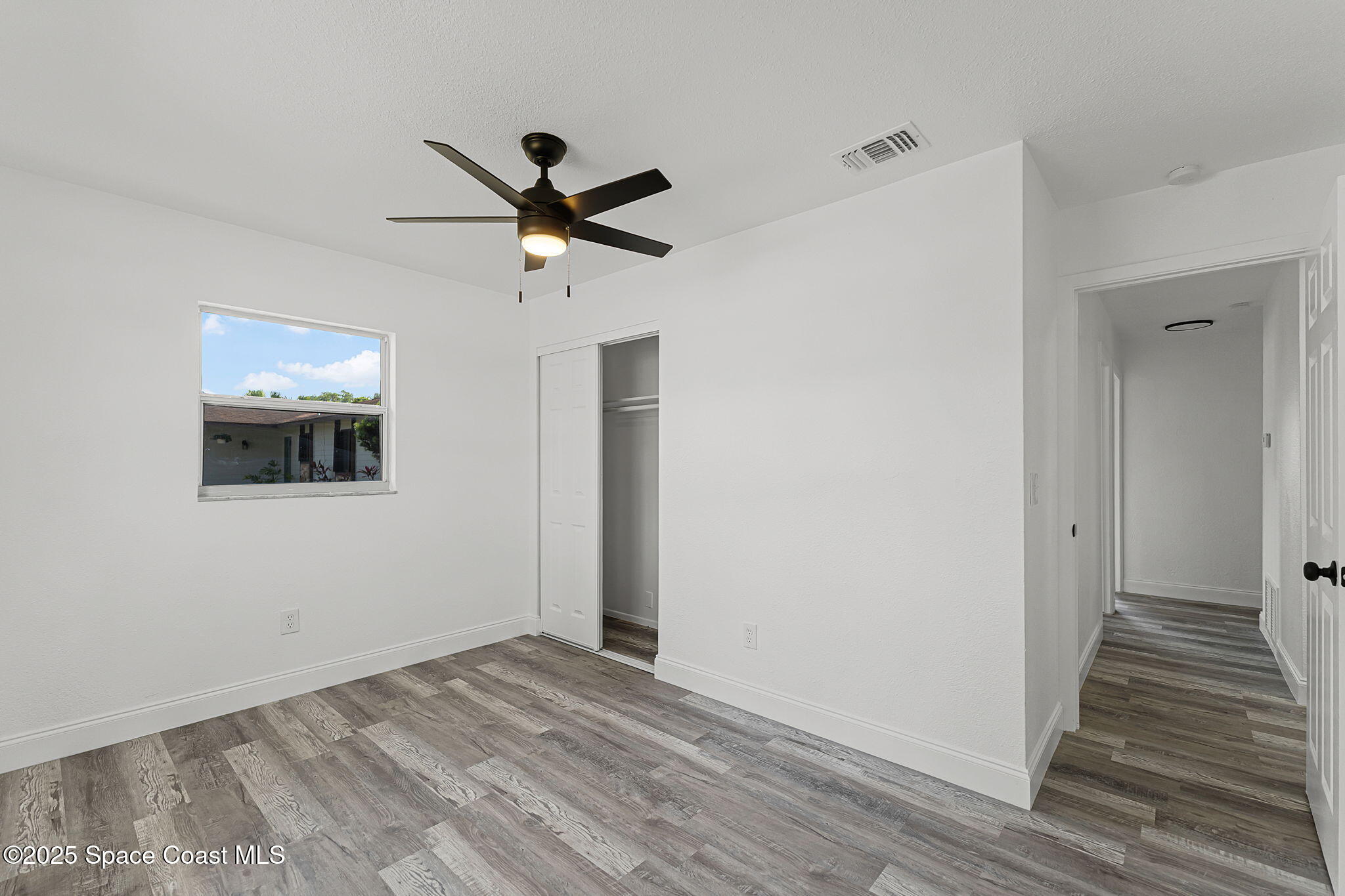 2412 Yule Tree Drive Edgewater, FL 32141 - Photo 23 of 35 a view of a livingroom with a hardwood floor and a ceiling fan