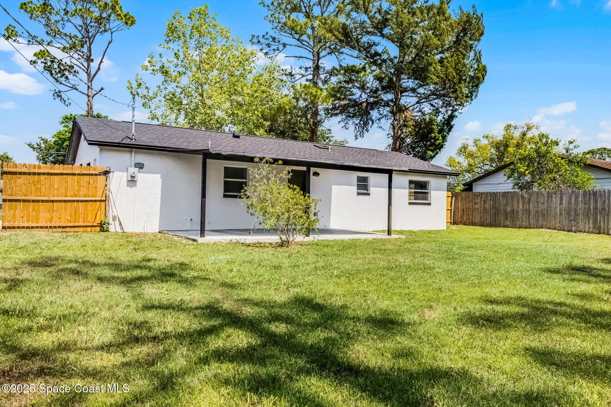 2412 Yule Tree Drive Edgewater, FL 32141 - Photo 24 of 35 a backyard of a house with plants and large tree