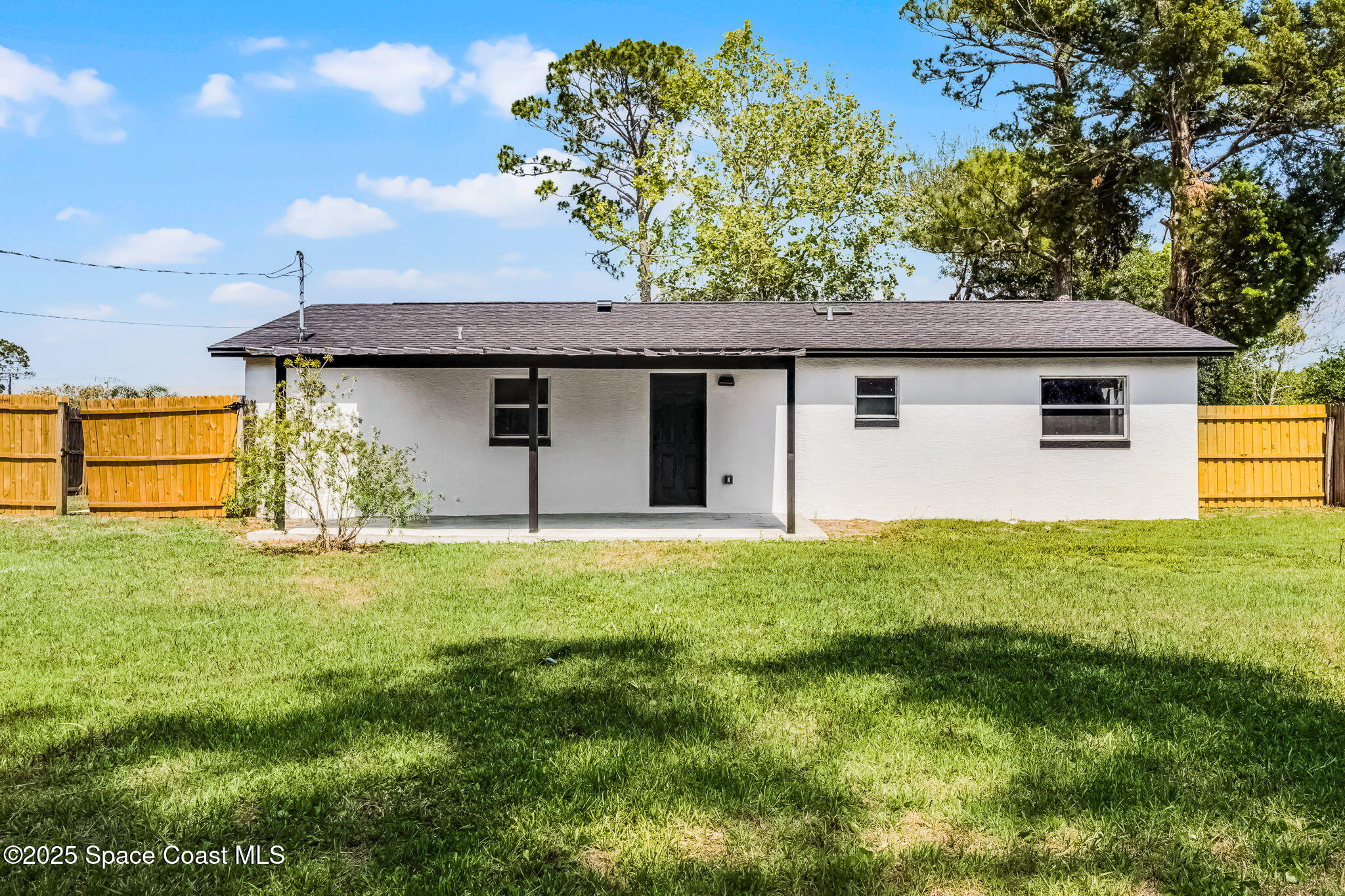 2412 Yule Tree Drive Edgewater, FL 32141 - Photo 25 of 35 a view of a backyard with plants and large tree