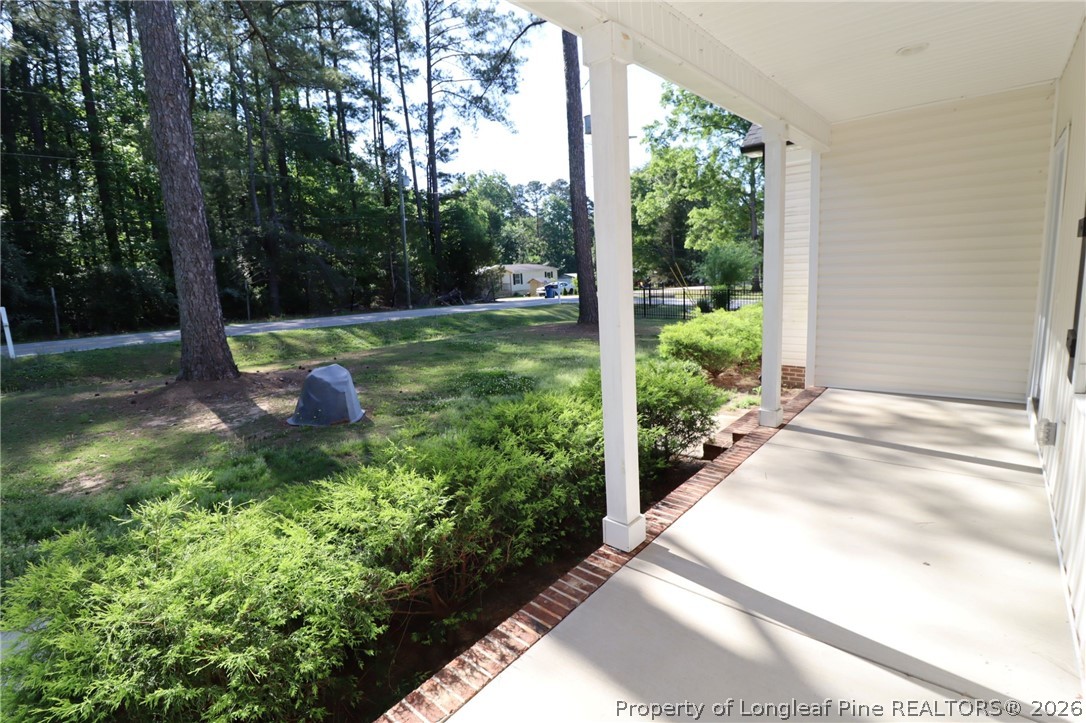 8424 Rhodes Road Apex, NC 27539 - Photo 2 of 31 a backyard of a house with lots of green space