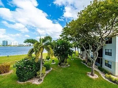 a view of a garden with a building in the background