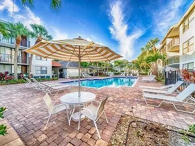 a patio with a yard table and chairs