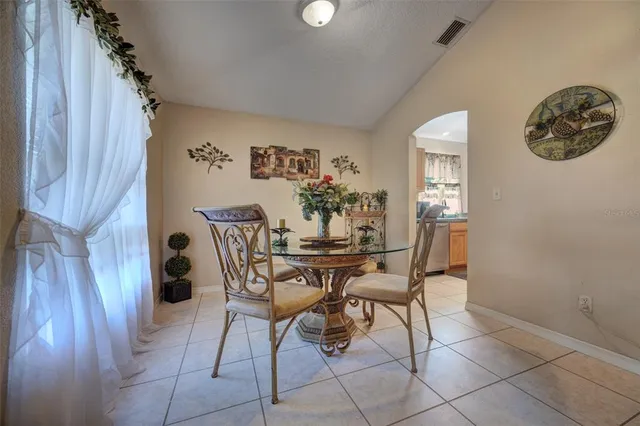 a view of a dining room with furniture and chandelier