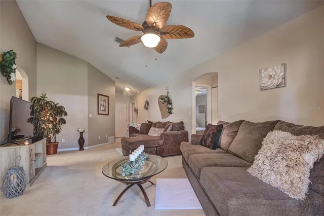 a living room with furniture a rug and a flat screen tv