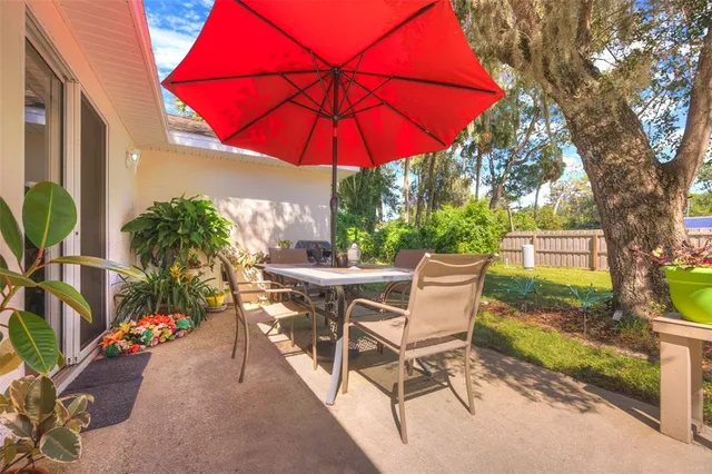 a patio with a patio table and chairs