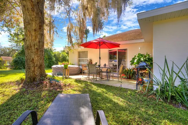 an outdoor space with seating area and trees