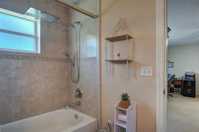 a bathroom with a tub a sink and a shower