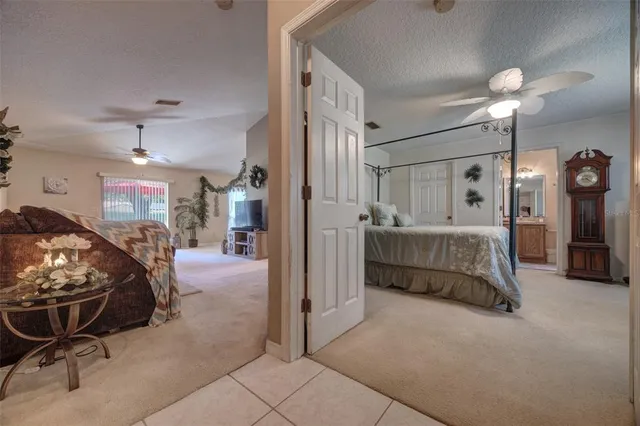 a spacious bedroom with a bed a table and chair