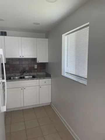 an empty room with wooden floor and door