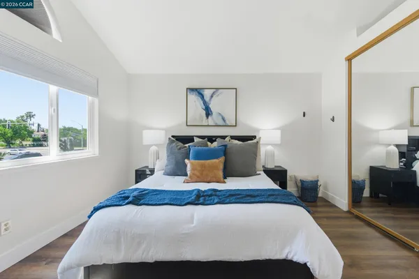 a bedroom with a bed and wooden floor