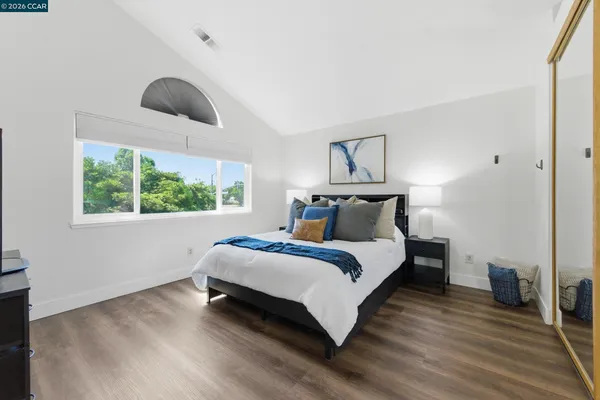 a bedroom with a bed and a large window