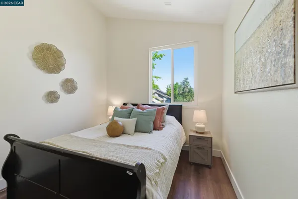 a bedroom with a bed and a potted plant