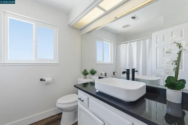 a bathroom with a sink toilet and a mirror