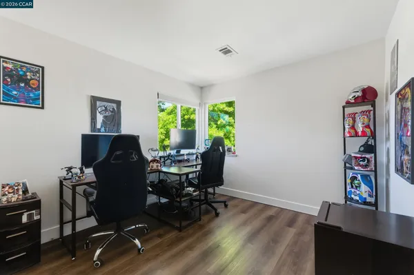 a view of a workspace with furniture and a window