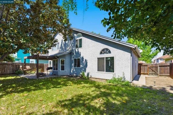 a view of a house with backyard sitting area and garden