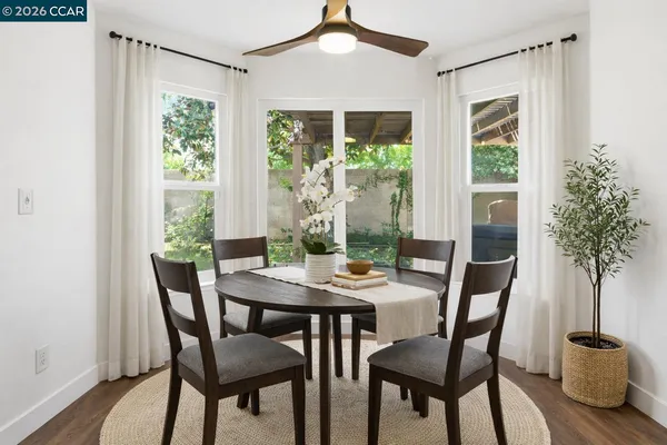 a view of a dining room with furniture window and wooden floor