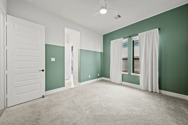an empty room with closet and a bathroom