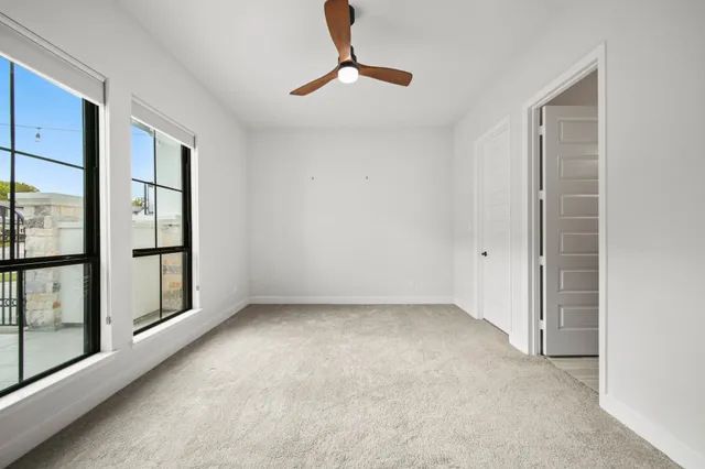 an empty room with windows and entrance