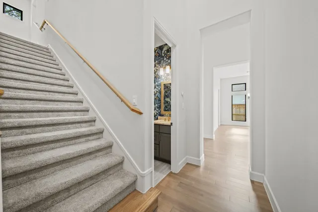 a view of entryway and hall with wooden floor
