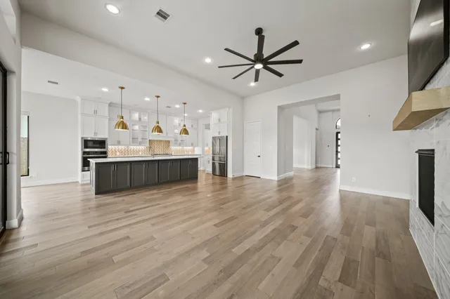 a view of a kitchen with a sink and wooden floor