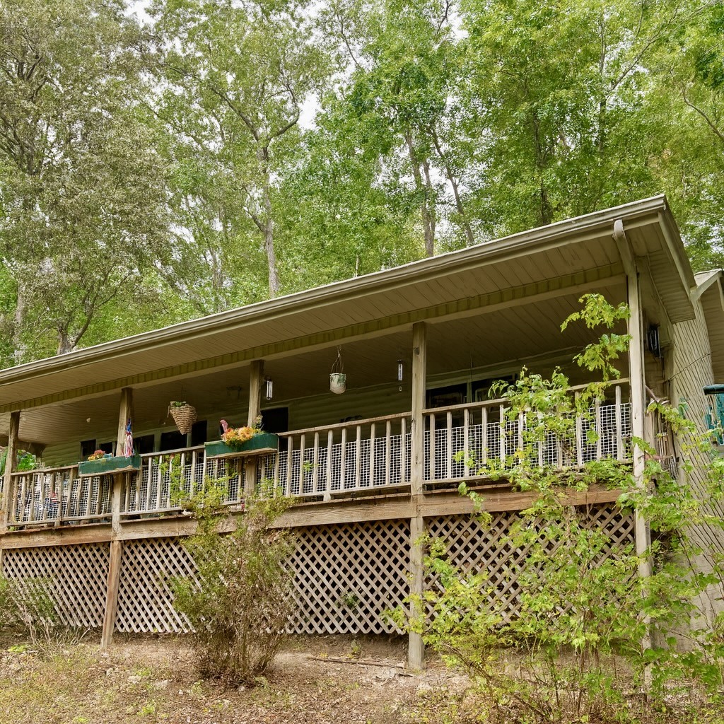 a view of a balcony with two chairs and wooden fence