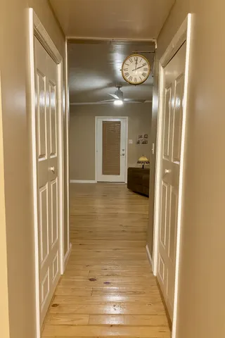 a bedroom with a chair and a flat screen tv