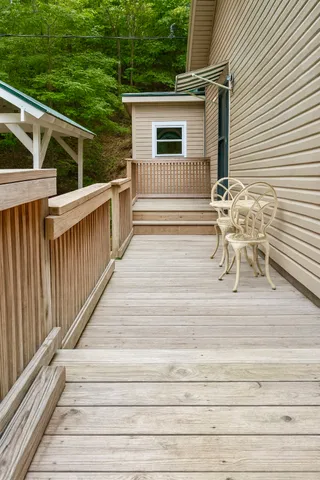 a view of backyard with deck and wooden floor