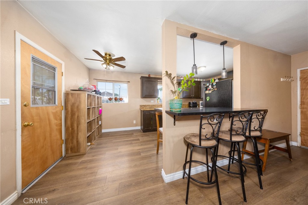 566 South Sage Avenue Rialto, CA 92376 - Photo 11 of 28 a dining room with furniture and wooden floor