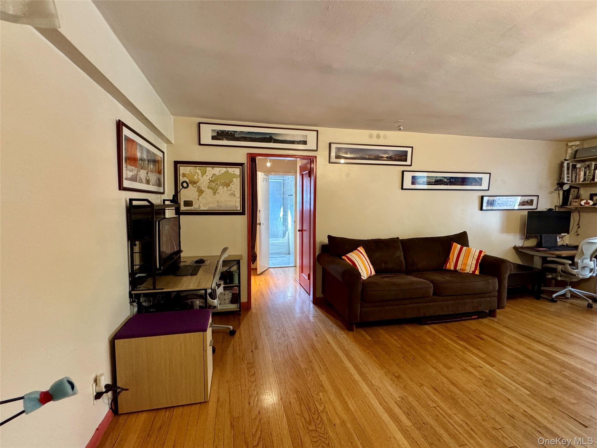 65-45 Yellowstone Boulevard, Unit 2A Queens, NY 11375 - Photo 2 of 9 a living room with furniture and a flat screen tv