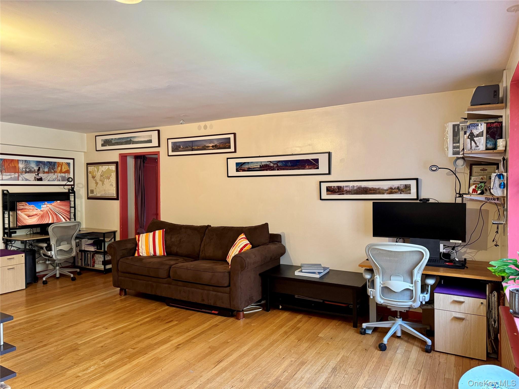 65-45 Yellowstone Boulevard, Unit 2A Queens, NY 11375 - Photo 3 of 9 a livingroom with workspace and a couch