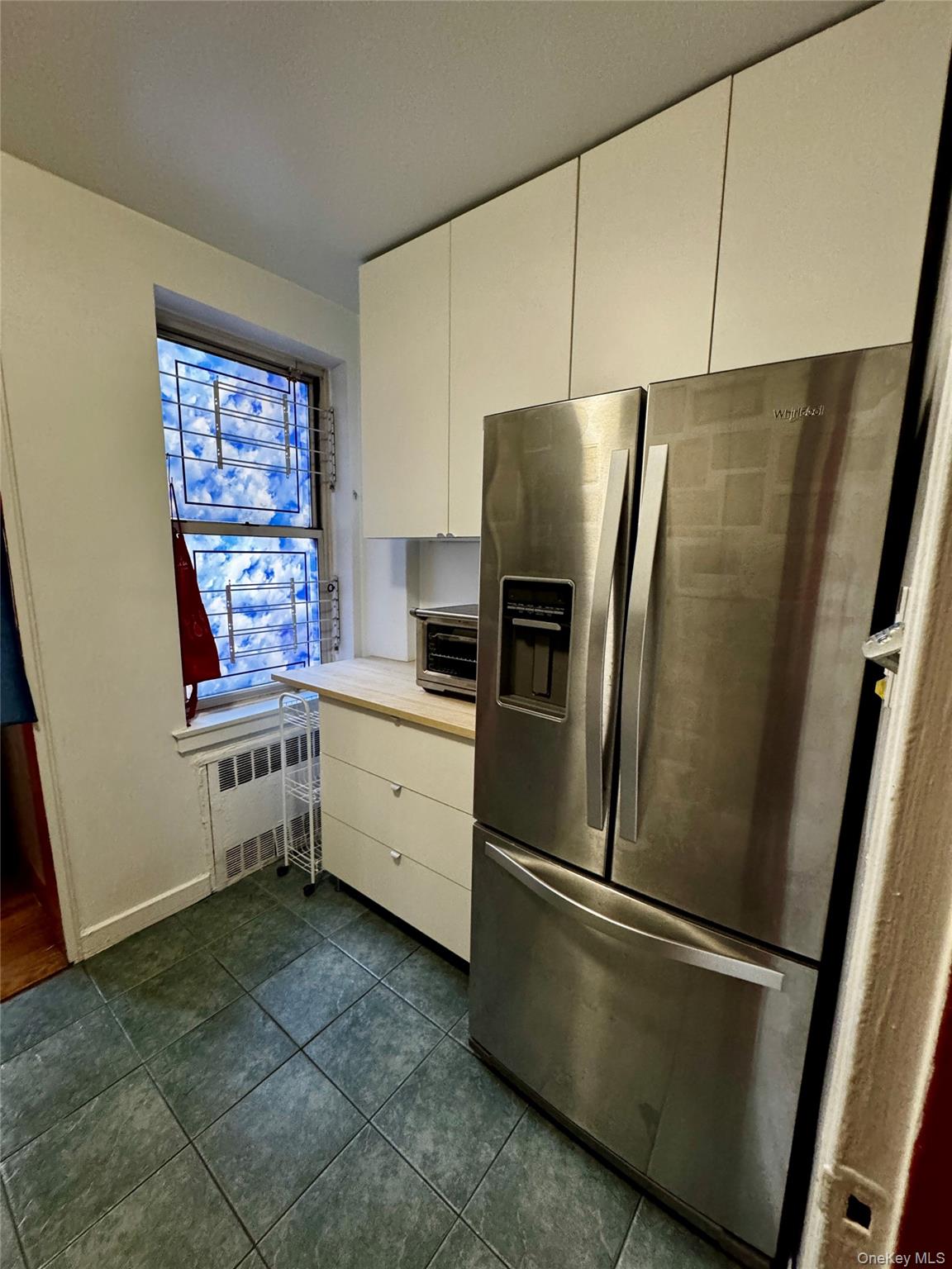 65-45 Yellowstone Boulevard, Unit 2A Queens, NY 11375 - Photo 5 of 9 a kitchen with stainless steel appliances a refrigerator sink and microwave