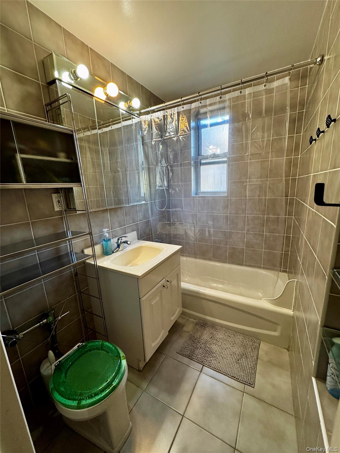 65-45 Yellowstone Boulevard, Unit 2A Queens, NY 11375 - Photo 9 of 9 a bathroom with a sink toilet and shower