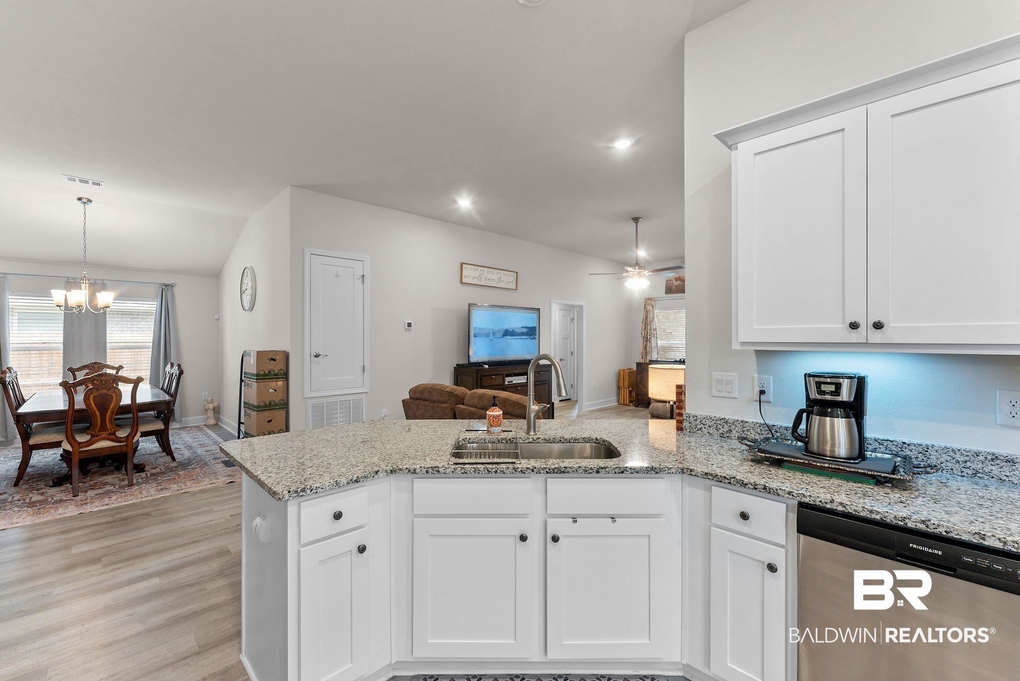 692 Mayflower Drive Foley, AL 36535 - Photo 39 of 40 Kitchen with a peninsula, stainless steel dishwasher, white cabinetry, and open floor plan
