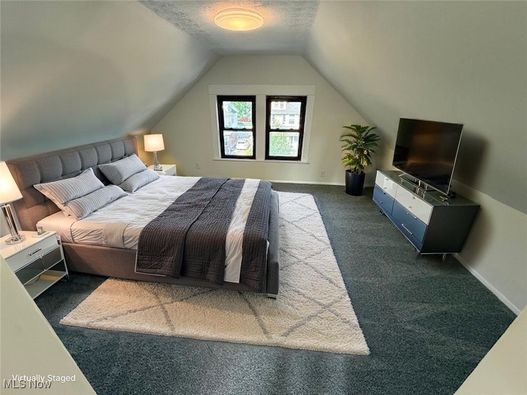 4018 Root Road North Olmsted, OH 44070 - Photo 18 of 23 Bedroom with dark carpet and lofted ceiling