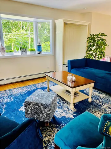 a living room with couch and a large window