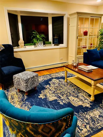 a living room with a rug table and a large window