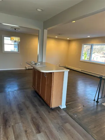a view of a livingroom with furniture wooden floor and a fireplace