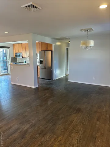 a view of kitchen with kitchen island and wooden floor