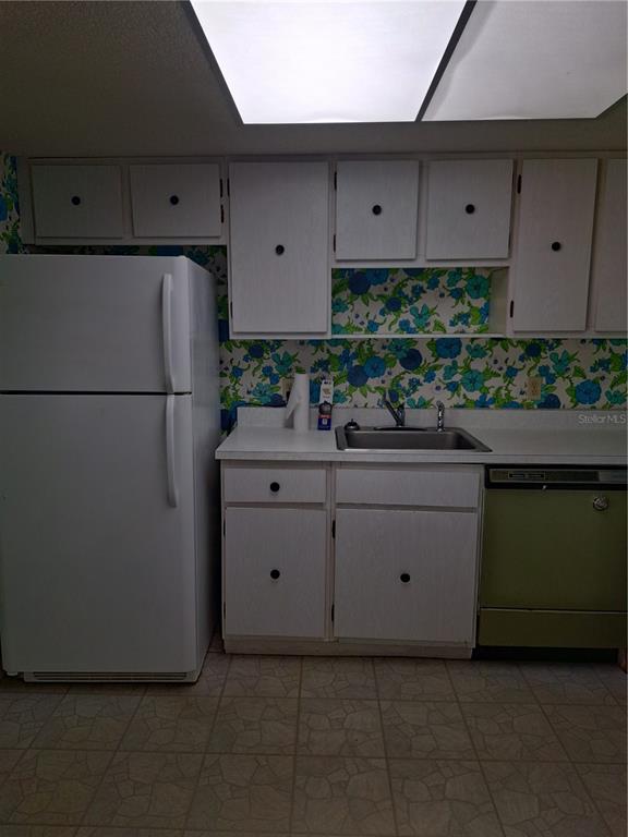 580 Fairways Circle, Unit A Ocala, FL 34472 - Photo 11 of 15 a kitchen with cabinets and white appliances