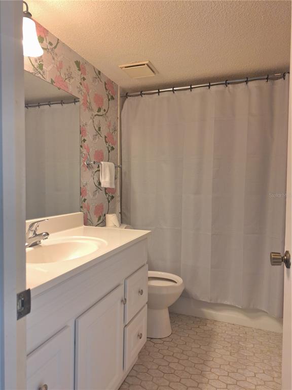 580 Fairways Circle, Unit A Ocala, FL 34472 - Photo 5 of 15 a bathroom with a granite countertop sink and a mirror