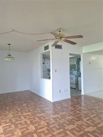 a view of a livingroom with a ceiling fan and window